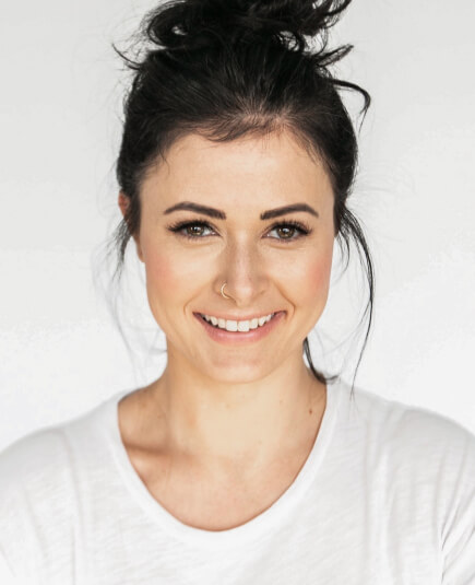 a smiling woman wearing white shirt