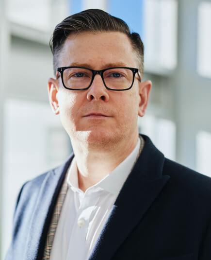 a guy wearing eyeglasses and in blue suit